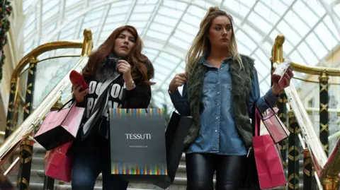 Two women shopping in Manchester's Trafford Centre.