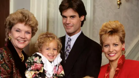 Getty Images Hayden Panettiere aged about four being held by and posing with three adult co-stars of One Life to Live