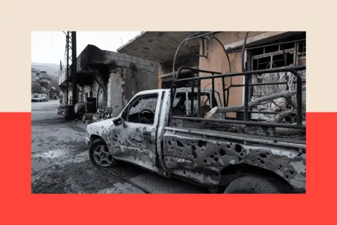 Dia Images via Getty Images A destroyed vehicle in Syria