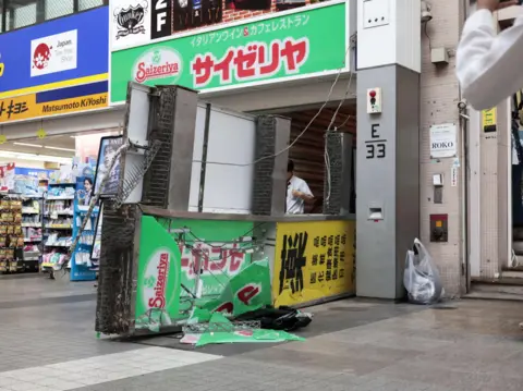 Reuters A damaged fallen signboard outside a Saizeriya restaurant after an earthquake with a preliminary magnitude of 7.1 struck Japan's southern Kumamoto prefecture.