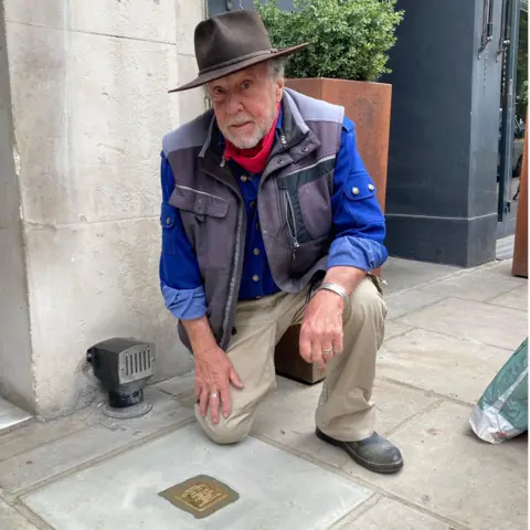 Jersey Heritage Gunter Demnig with an example of a Stolperstein