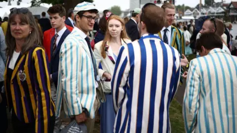 Getty Images Spectators wait for the start of a race on the River Thames at the Henley Royal Regatta in Henley-on-Thames on June 30, 2023.