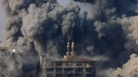 Smoke billows following Israeli strikes on the Islamic University of Gaza in 2023