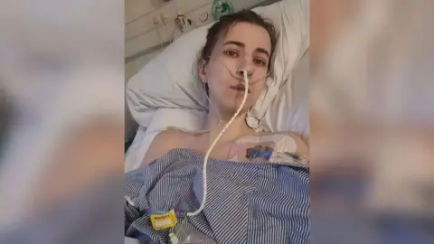 Faye Louise Faye Louise in a hospital bed with a drip looking poorly.