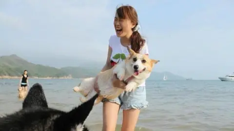 Kasumi Law A laughing Kasumi with her dogs at Lamma Island, Hong Kong