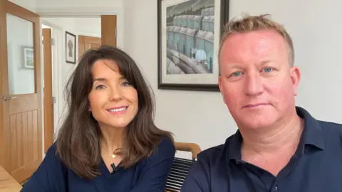 James's parents Lindsay and Neil Humphries, sitting in their home and looking at the camera