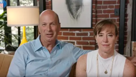 US Mission to EU In a US embassy video, Mr Sondland introduces his wife Katy Durant (R) and their two children