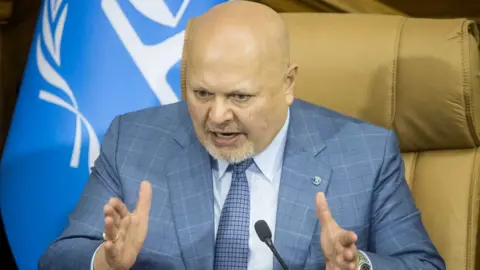 Chief prosecutor of the ICC, Karim Khan, wearing a blue suit 