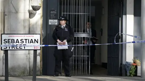 PA Media Flowers laid at police cordon at Arbour House