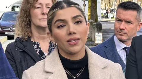 Hiria Veisi outside court after the sentencing, dressed in a cream coloured coat