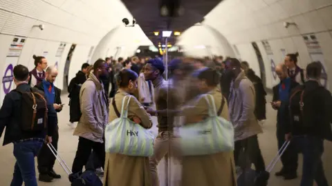 Reuters Passengers boarding a train