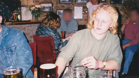 Roddy Russell Rob Russell at a pub table, with pint of beer on the table in front of him