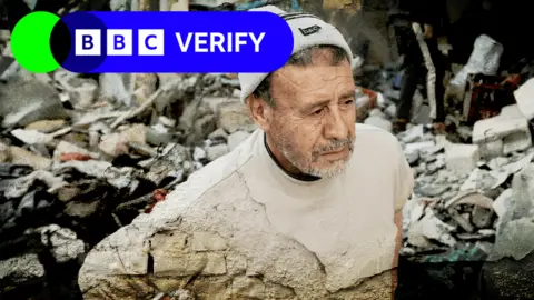 An image of a solemn man surveying the rubble and damage