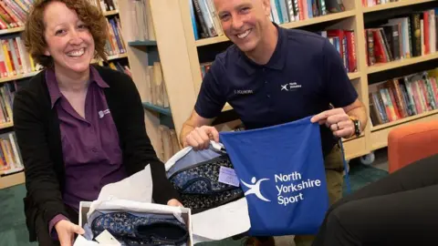 Toria Morris, library supervisor at Malton, and Simon Pierce, health and wellbeing manager at North Yorkshire Sport at a slipper event