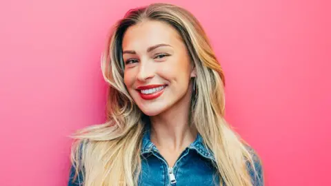 Zara McDermott smiling and looking at the camera