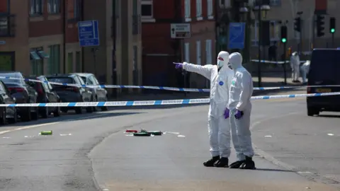 Forensic officers inside a police cordon in Nottingham on the day of the attacks in June 2023. 