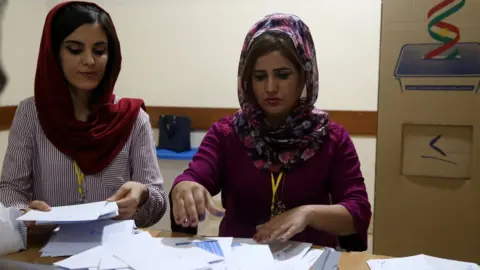 EPA Kurdish electoral officials count votes from an independence referendum in Irbil, northern Iraq (25 September 2017)