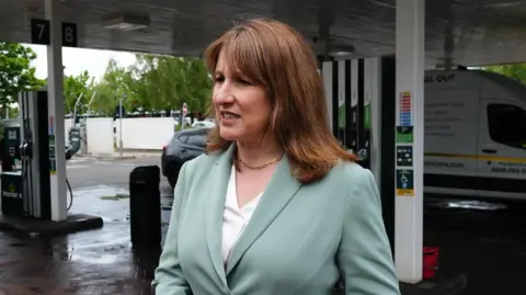 Rachel Reeves speaks to reporters on a petrol station forecourt