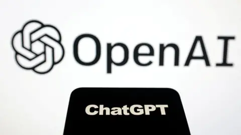 Reuters The OpenAI logo on a large white screen, with the ChatGPT logo on a black phone face in front of it.