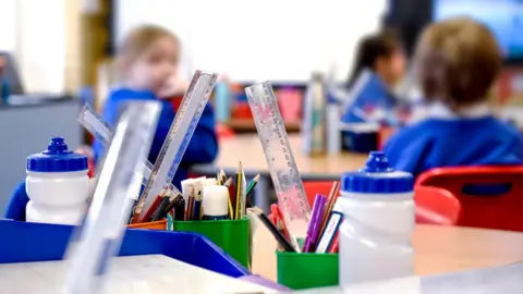 Getty Images A stock image of a school with pencils, rulers, cups and bottles on the desk