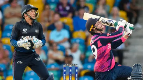 Namibia wicketkeeper Zane Green watches Scotland's Michael Leask hit out during a T20 World Cup match in 2024