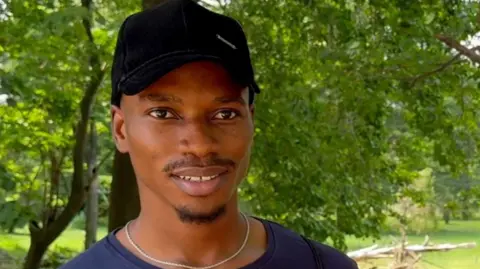 BBC Young man in a baseball cap