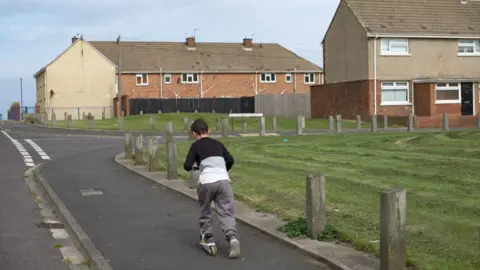 Getty Images A boy plays in an area of deprivation