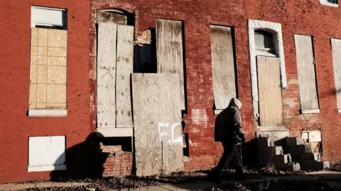 Getty Images Abandoned buildings stand in a neighbourhood with a high murder rate on February 3, 2018 in Baltimore, Maryland.