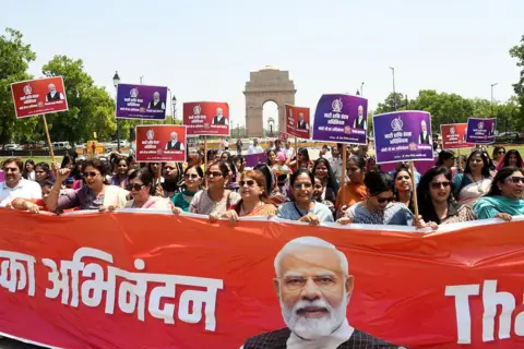 Hindustan Times via Getty Images Women form a human chain to express support and gratitude to Prime Minister Narendra Modi for moving to fast-track the implementation of the historic legislation the Nari Shakti Vandan Adhiniyam (Women's Reservation Act) in Parliament, at India Gate on April 14, 2026 in New Delhi, India. The proposed legislation would allow for 33 percent reservation to be operationalized by the 2029 Lok Sabha elections by using data from the 2011 Census or an interim delimitation formula. (Photo by Ishant Chauhan/Hindustan Times via Getty Images)