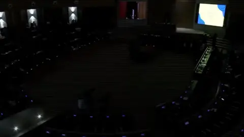 MPs sitting in the darkness