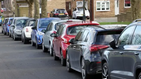 A row of parked cars on Douglas Terrace in Newcastle.