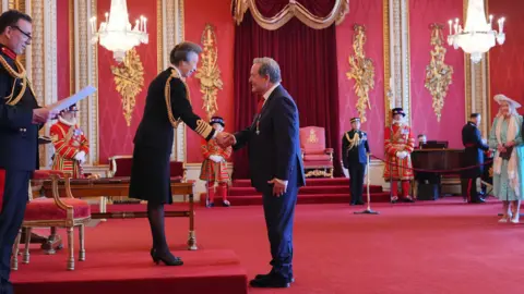 PA Media Jeff Stelling shaking hands with the Princess Royal at Buckingham Palace as he is made MBE