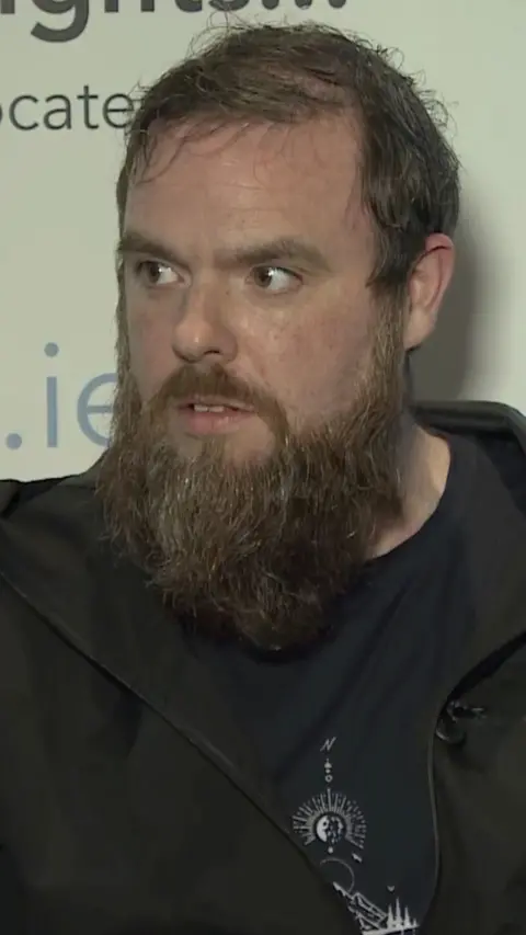 Paul Wilson with a beard and wearing a black hoody