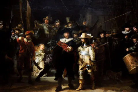 Getty Images The Night Watch shows a captain and lieutenant surrounded by their company