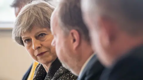 PA Theresa May at round table event in south Wales