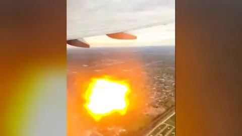 Fireball from plane engine seen from passenger window