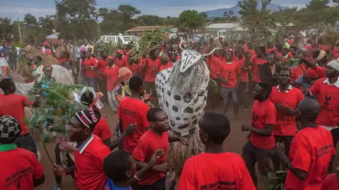Getty Images A large group of people dancing with a "beast spirit" - Sunday 12 May