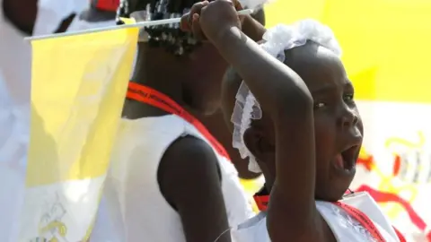 Reuters A girls yawns while waiting for the Pope at the Cathedral of Saint Therese in Juba, South Sudan - Saturday 4 February 2023