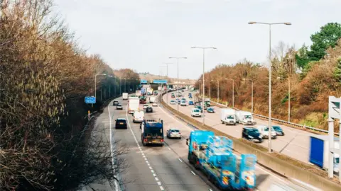 Karl Hendon/Getty Images Cars driving on a UK motorway