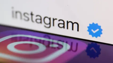 Getty Images Instagram logo displayed on a smartphone with a blue verification badge