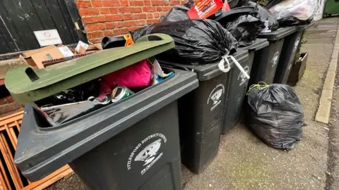 Stuart Woodward/BBC Overflowing bins in Great Dunmow, Essex