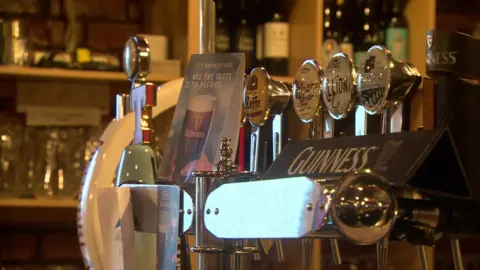 BBC Beer pumps at a bar