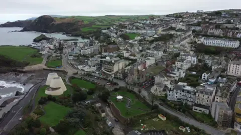 Aerial view of a seaside town, grey skies.