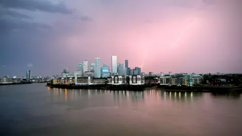 A lightning bolt is seen above building in Canary Wharf
