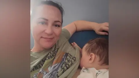Supplied A woman breastfeeding her baby 