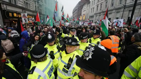 PA Media Police officers among the crowd of a pro-Palestine protest