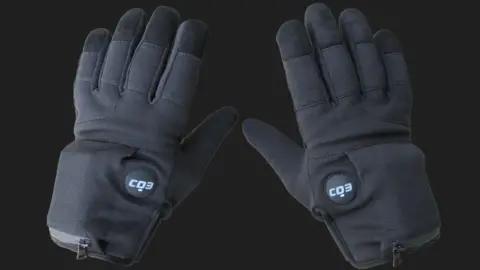 Compliant Technologies A pair of grey gloves with a button near the thumb that reads "CD3"