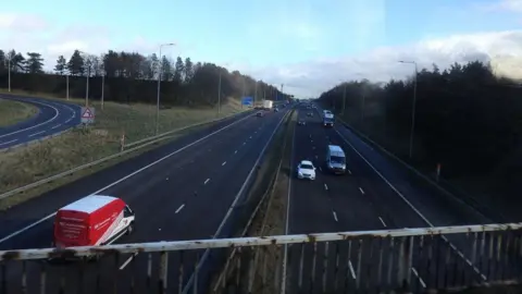 Geograph/ Stephen Armstrong Motorway with three lanes on either side from the view of a bridge.