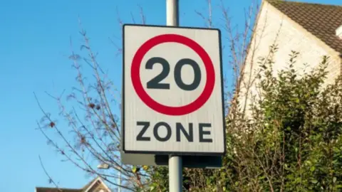 A 20mph speed limit zone sign in a residential area