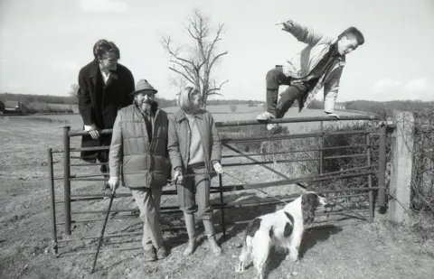 Getty Images English actor Maggie Smith with her family in their country home in Sussex.  Husband Beverley Cross and her two sons. Chris watches his brother Toby as he vaults the gate in 1986 (photo by Ian Cook/Getty Images)